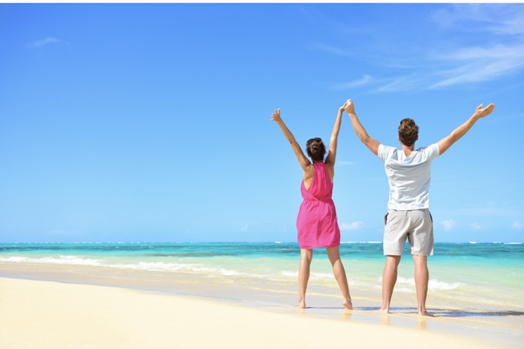 a couple with hands in hand at the beach